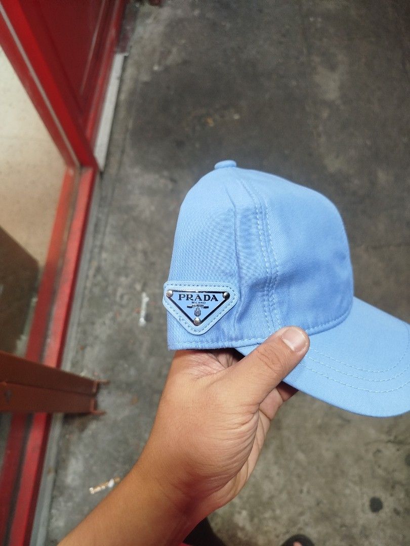 Prada Light Blue Nylon Baseball Cap (Category: Caps & Hats) located in Manila. Submitted by alenoid (Listing ID 1469802521, Image 2). Description: - Authentic Prada baseball cap in a stylish light blue shade - Brand new with tags (BNWT) attached - Material: 100% durable nylon with 100% comfortable cotton lining - Features the iconic enameled metal triangle Prada Milano logo on the side - Adjustable back strap for a customized fit - Perfect for ev