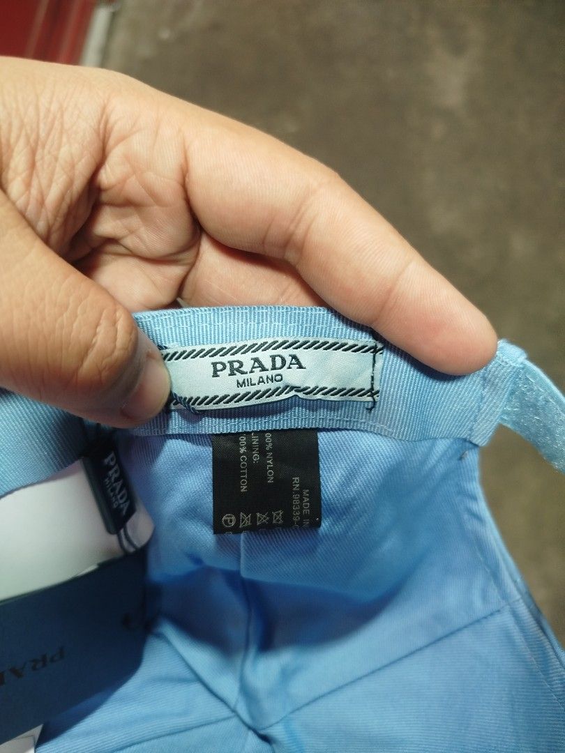 Prada Light Blue Nylon Baseball Cap (Category: Caps & Hats) located in Manila. Submitted by alenoid (Listing ID 1469802521, Image 3). Description: - Authentic Prada baseball cap in a stylish light blue shade - Brand new with tags (BNWT) attached - Material: 100% durable nylon with 100% comfortable cotton lining - Features the iconic enameled metal triangle Prada Milano logo on the side - Adjustable back strap for a customized fit - Perfect for ev