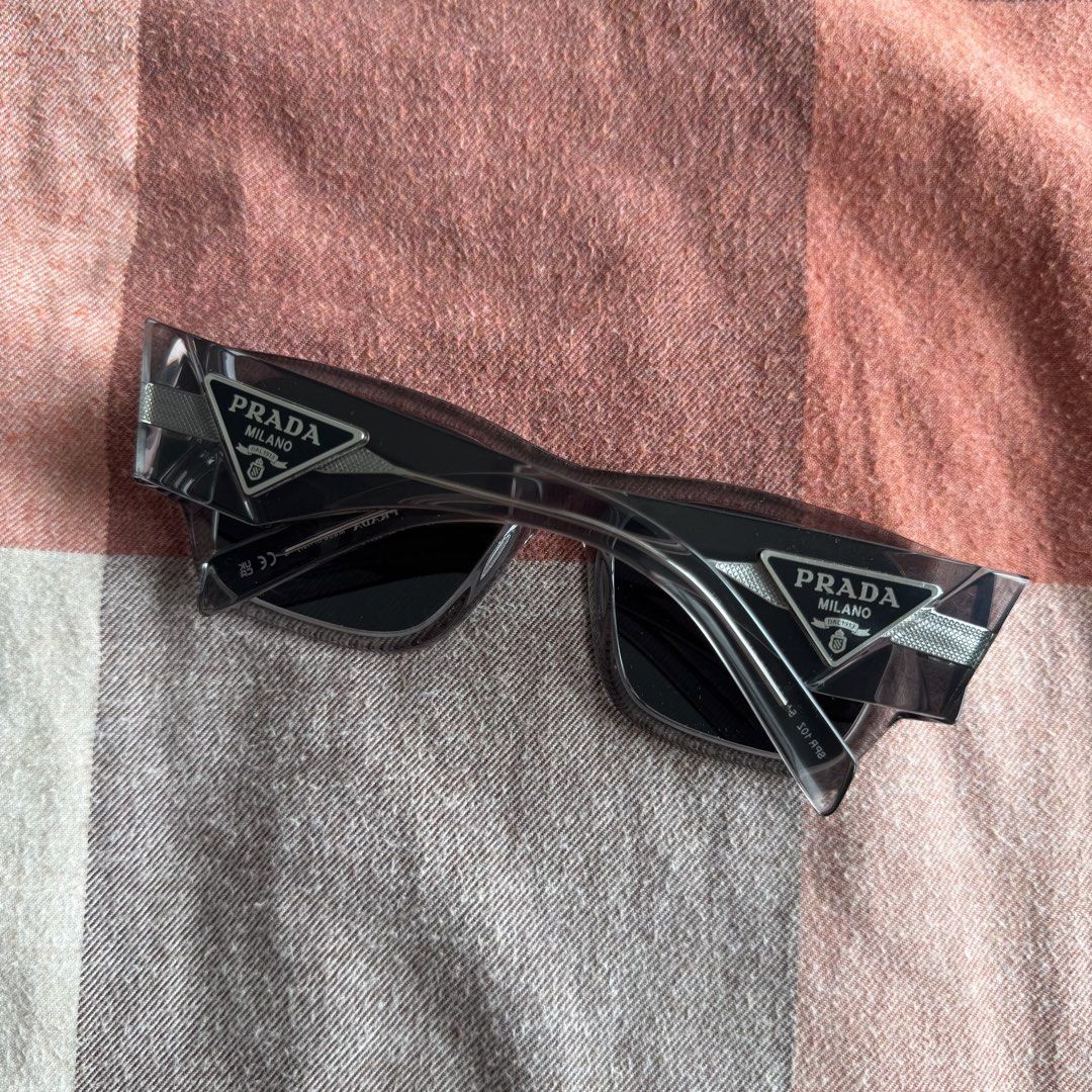 Prada Sunglasses (Category: Sunglasses & Eyewear) located in Makati City. Submitted by gelo_mp99 (Listing ID 1469771871, Image 2). Description: includes the carrying case and cleaning cloth.