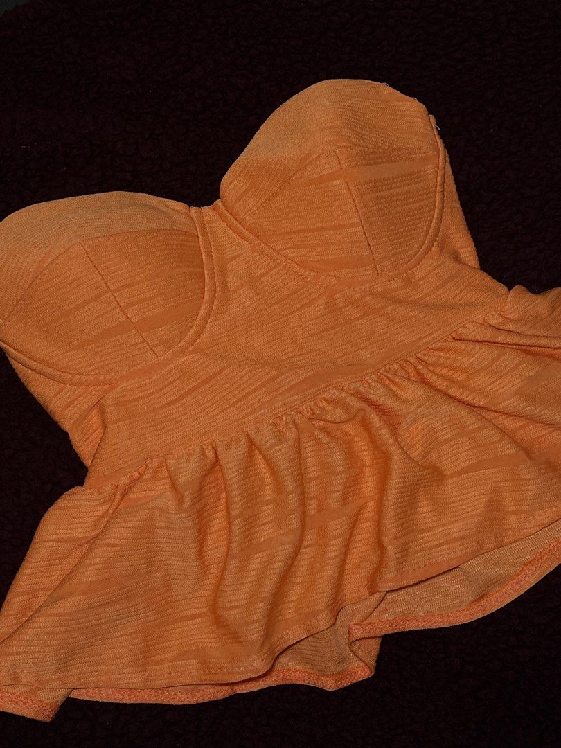 Pre loved Orange Strapless Corset Peplum Top (Category: Sleeveless) located in Manila. Submitted by kyelleanne (Listing ID 1469902441, Image 1). Description: Bright orange textured fabric, strapless bustier style with structured cups. Flared peplum hem adds volume at the waist. Zip or slip-on design, lightweight material. Great color for summer nights out or parties. Fits true to standard sizing..