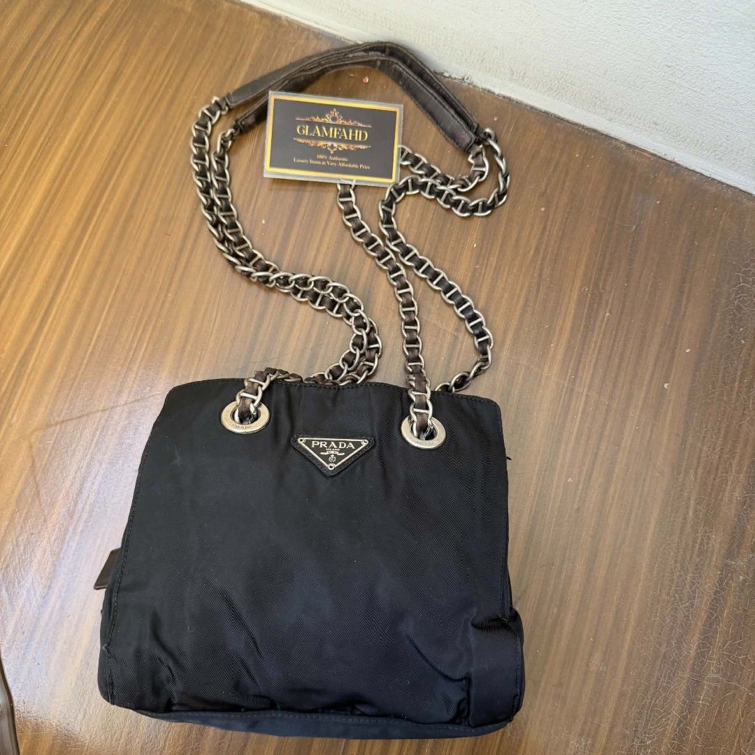 PRE OWNED AUTHENTIC PRADA NYLON VINTAGE CHAIN SHOULDER BAG (Category: Luxury Bags & Wallets) located in Paranaque City. Submitted by Glamfahd (Listing ID 1469879584, Image 1). Description: Pre Owned Authentic PRADA Bag Inclusion/s: None Condition Well Used condition Marks on exterior Marks on interior Bag is really a great buy! Please manage your expectations as you are buying an authentic second hand item at a fraction of the cost.