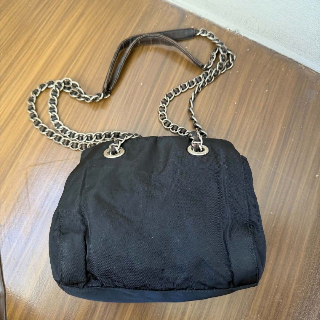 PRE OWNED AUTHENTIC PRADA NYLON VINTAGE CHAIN SHOULDER BAG (Category: Luxury Bags & Wallets) located in Paranaque City. Submitted by Glamfahd (Listing ID 1469879584, Image 2). Description: Pre Owned Authentic PRADA Bag Inclusion/s: None Condition Well Used condition Marks on exterior Marks on interior Bag is really a great buy! Please manage your expectations as you are buying an authentic second hand item at a fraction of the cost.
