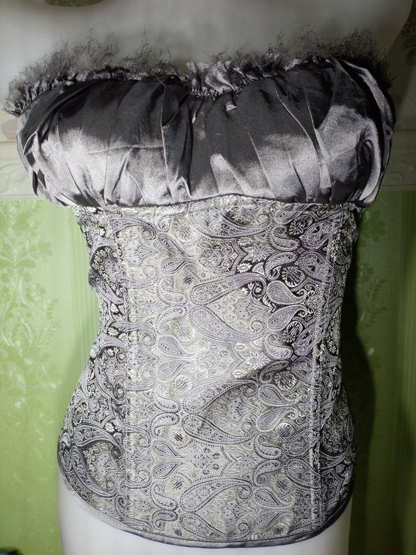Preloved Gothic Brocade Gray Corset Top Xl (Category: Others Tops) located in Dasmarinas. Submitted by ms.happycorsets (Listing ID 1469907920, Image 2). Description: Preloved Brocade Corset Top light Gray Color Brocade design Can Fit to Etra large size Semi Stretchable Fabric Starting waistline size 36-39 inches With 8 Soft bones Has Lace Tie adjustable At the Back Padded no underwrite 36-38 B with Slight flaws see photos in the bra part satin fa