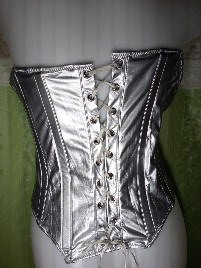 Preloved Silver Corset Top XL (Category: Others Tops) located in Dasmarinas. Submitted by ms.happycorsets (Listing ID 1469897286, Image 3). Description: Preloved Silver Corset Top Silver Color Can Fit Extra large size Starting waistline 34-36 inches Starting Bust Size 40 inches length 16 inches Stretchable Fabric Not Padded Has Lace tie Adjustable at the back Has Front Zipper Has 8 Soft bones with Slight flaws Actual Photo Color may Change due to
