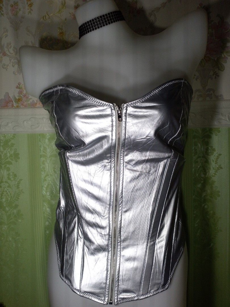 Preloved Silver Corset Top XL (Category: Others Tops) located in Dasmarinas. Submitted by ms.happycorsets (Listing ID 1469897286, Image 1). Description: Preloved Silver Corset Top Silver Color Can Fit Extra large size Starting waistline 34-36 inches Starting Bust Size 40 inches length 16 inches Stretchable Fabric Not Padded Has Lace tie Adjustable at the back Has Front Zipper Has 8 Soft bones with Slight flaws Actual Photo Color may Change due to