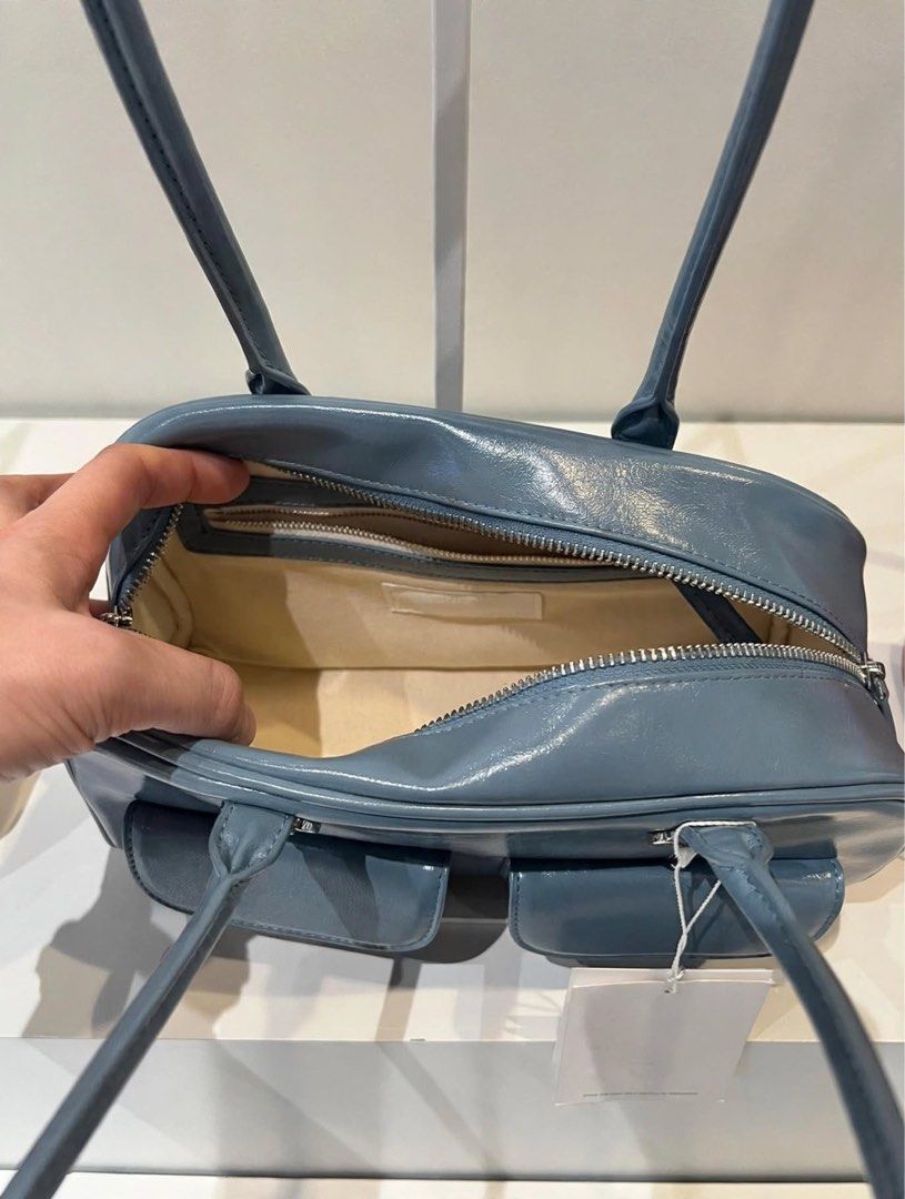 PREORDER Authentic Stand Oil Chubby Bag Sky Blue (Category: Shoulder Bags) located in Manila. Submitted by essential.shop.ph (Listing ID 1469888904, Image 2). Description: PREORDER 10-12 days ETA ☺️ ‘CHUBBY BAG’ – A Round, Chubby Body, Retro Bowling Style Bag - Crinkle faux patent with wrinkles and gloss - Vintage mood handle decoration, soft double-sided zip - Pocket Details: 2 front mini flap pockets, 1 back welt pocket, 2 interior open pockets