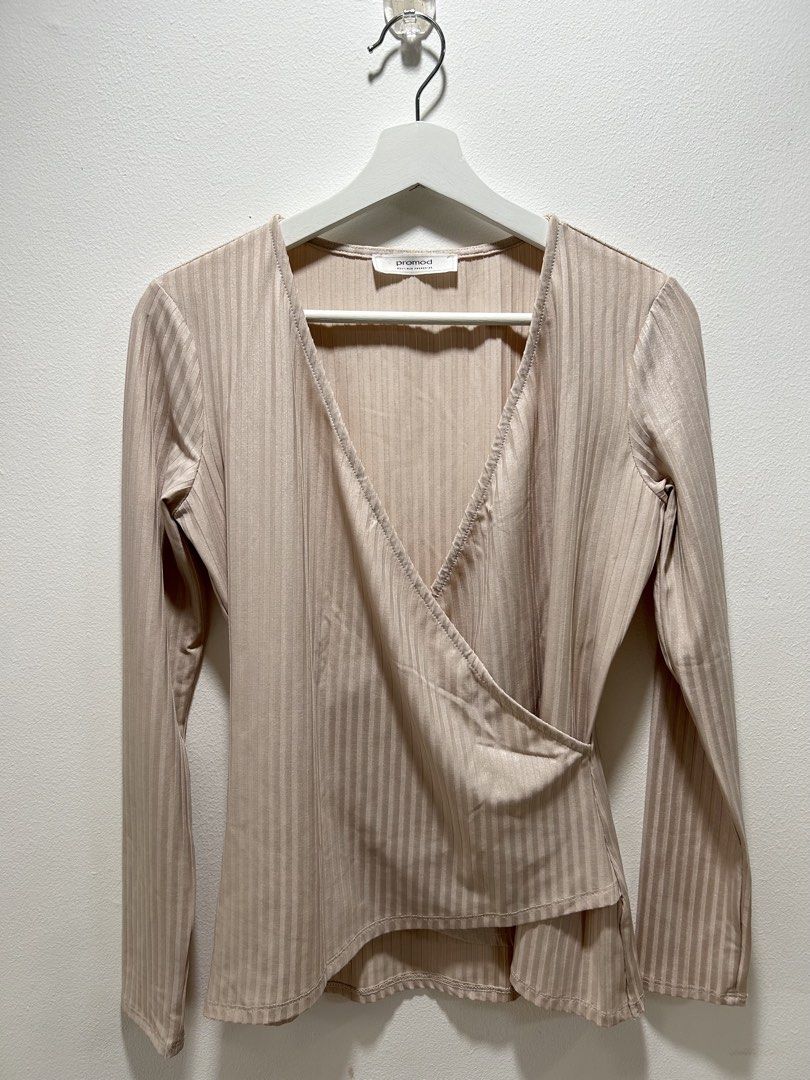 Promod Beige Ribbed Wrap Long Sleeve Blouse (Category: Longsleeves) located in Manila. Submitted by isabelle_1104 (Listing ID 1469917996, Image 2). Description: Promod wrap top in beige. Long sleeves, ribbed texture throughout with a subtle shimmer. V-neck design with an asymmetric layered hem. French boutique brand label stitched inside the collar. Lightweight fabric, easy to pair with high-waisted jeans or skirts..