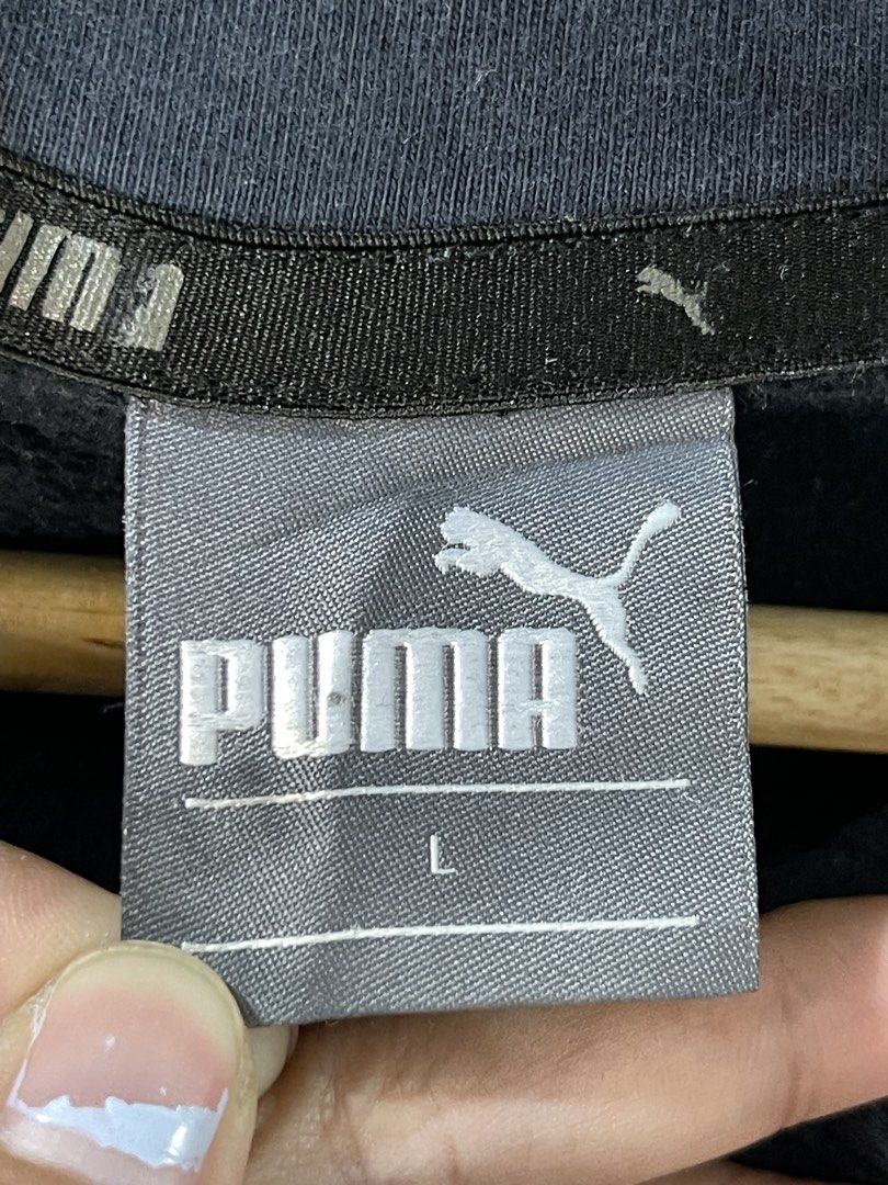 Puma Black Graphic Hoodie Size L (Category: Hoodies) located in Cabagan. Submitted by blessingma81004 (Listing ID 1469770352, Image 3). Description: Black Puma hoodie with bold white graphic text along the bottom hem. Size large tag attached. Drawstring hood, ribbed cuffs and hem. Style number 594776-01 on the inner wash tag. Has slight fading around the hoodline and needs a wash..