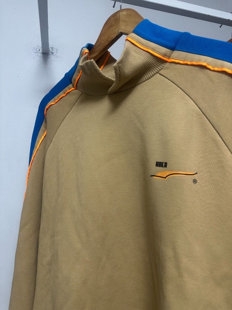 Puma x Ader Error Polo Shirt Tan Blue Size M (Category: Tshirts & Polo Shirts ) located in Manila. Submitted by rodeltzy (Listing ID 1469825536, Image 1). Description: - Brand: Puma x Ader Error - Style: Polo shirt with bright blue collar and orange piping - Color: Tan - Size: Medium (Standard US, CAN, and EUR sizing) - Material: Premium cotton pique fabric - Details: Iconic Puma leaping cat logo and Ader branding on inner collar - Authenticity: 