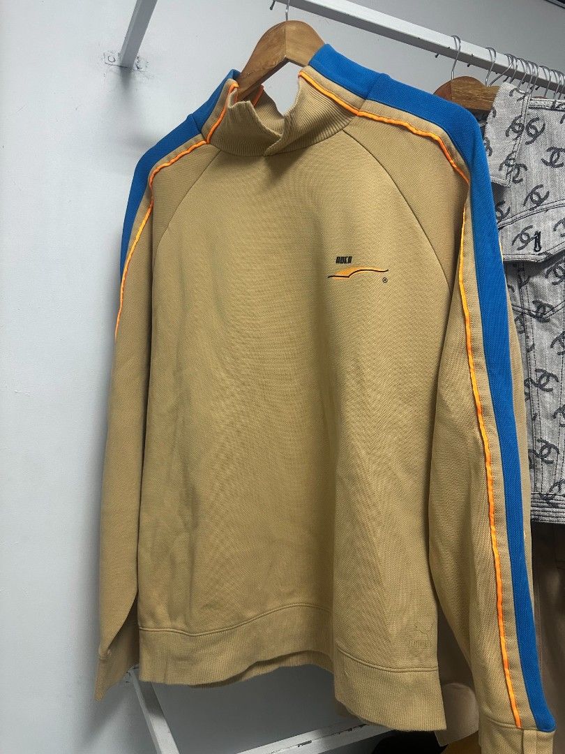 Puma x Ader Error Polo Shirt Tan Blue Size M (Category: Tshirts & Polo Shirts ) located in Manila. Submitted by rodeltzy (Listing ID 1469825536, Image 2). Description: - Brand: Puma x Ader Error - Style: Polo shirt with bright blue collar and orange piping - Color: Tan - Size: Medium (Standard US, CAN, and EUR sizing) - Material: Premium cotton pique fabric - Details: Iconic Puma leaping cat logo and Ader branding on inner collar - Authenticity: 