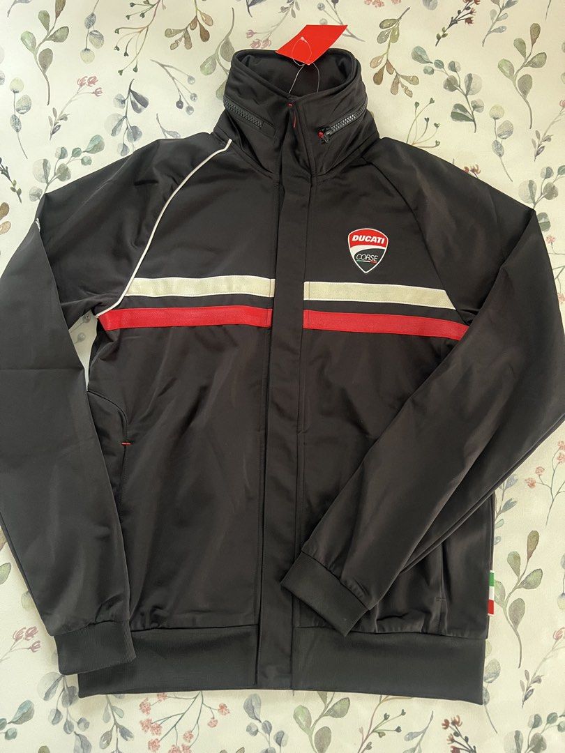 Puma x Ducati Corse Jacket Black Size M (Category: Coats, Jackets and Outerwear) located in Muntinlupa City. Submitted by 09leah77 (Listing ID 1469815333, Image 1). Description: - Brand: Puma x Ducati Corse - Color: Black with striking red and white chest stripes - Details: Iconic shield logo badge, stand collar with zipper, and comfortable ribbed cuffs and hem - Condition: Brand new with original tags attached - Article No.: 751306 01 - Perfect 