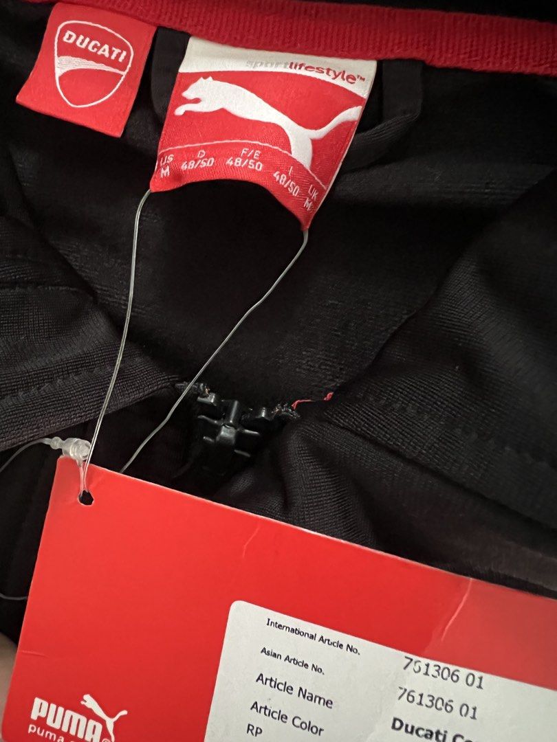 Puma x Ducati Corse Jacket Black Size M (Category: Coats, Jackets and Outerwear) located in Muntinlupa City. Submitted by 09leah77 (Listing ID 1469815333, Image 3). Description: - Brand: Puma x Ducati Corse - Color: Black with striking red and white chest stripes - Details: Iconic shield logo badge, stand collar with zipper, and comfortable ribbed cuffs and hem - Condition: Brand new with original tags attached - Article No.: 751306 01 - Perfect 
