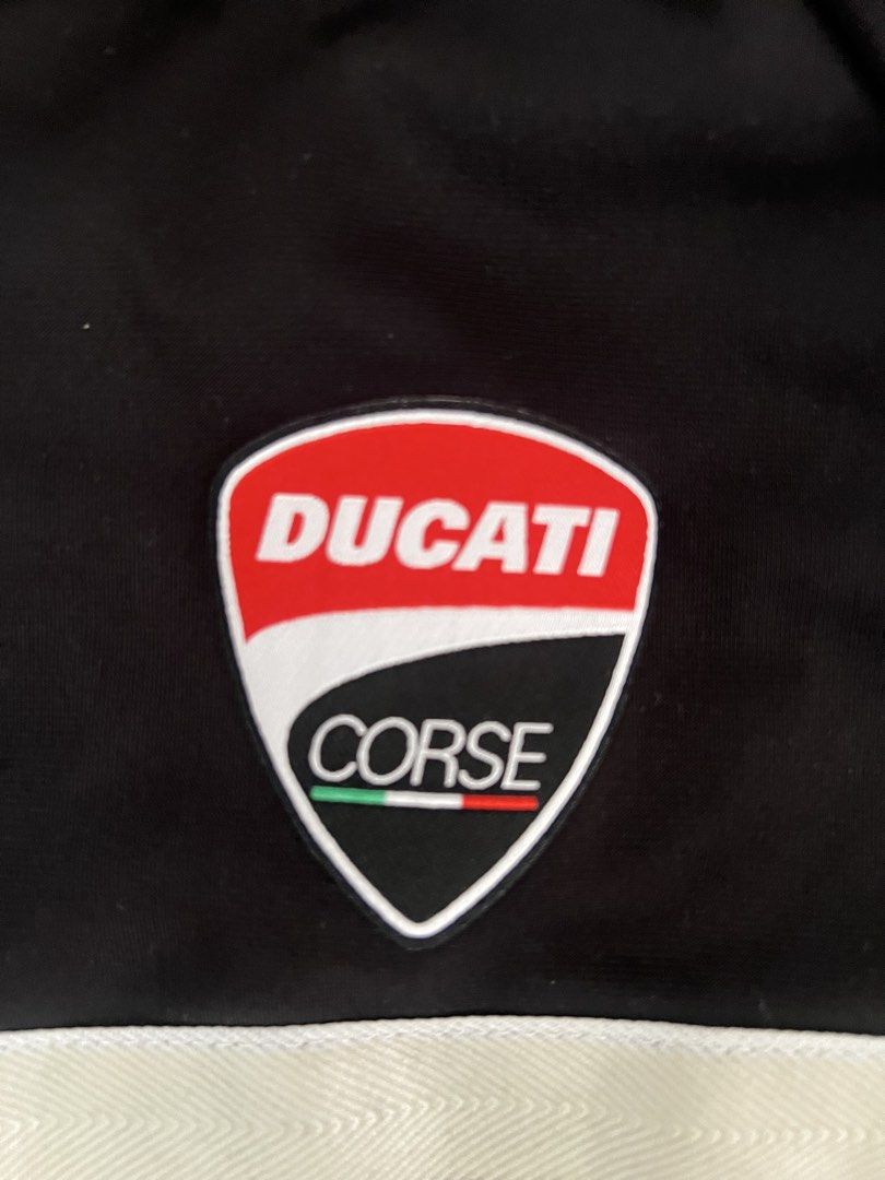 Puma x Ducati Corse Jacket Black Size M (Category: Coats, Jackets and Outerwear) located in Muntinlupa City. Submitted by 09leah77 (Listing ID 1469815333, Image 2). Description: - Brand: Puma x Ducati Corse - Color: Black with striking red and white chest stripes - Details: Iconic shield logo badge, stand collar with zipper, and comfortable ribbed cuffs and hem - Condition: Brand new with original tags attached - Article No.: 751306 01 - Perfect 