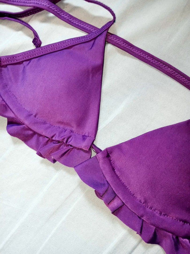 Purple Ruffle Triangle Bikini Set (Category: Bikinis & Swimsuits) located in Manila. Submitted by livelion.4e87e7 (Listing ID 1469769620, Image 2). Description: - Style: Two-piece bikini with vibrant bright purple color - Top: Triangle cut with delicate ruffle trim, adjustable halter neck, and back ties - Bottoms: Low-rise with thin side ties for a custom fit - Condition: Worn a few times, freshly washed, and ready to wear - Perfect for: Pool day