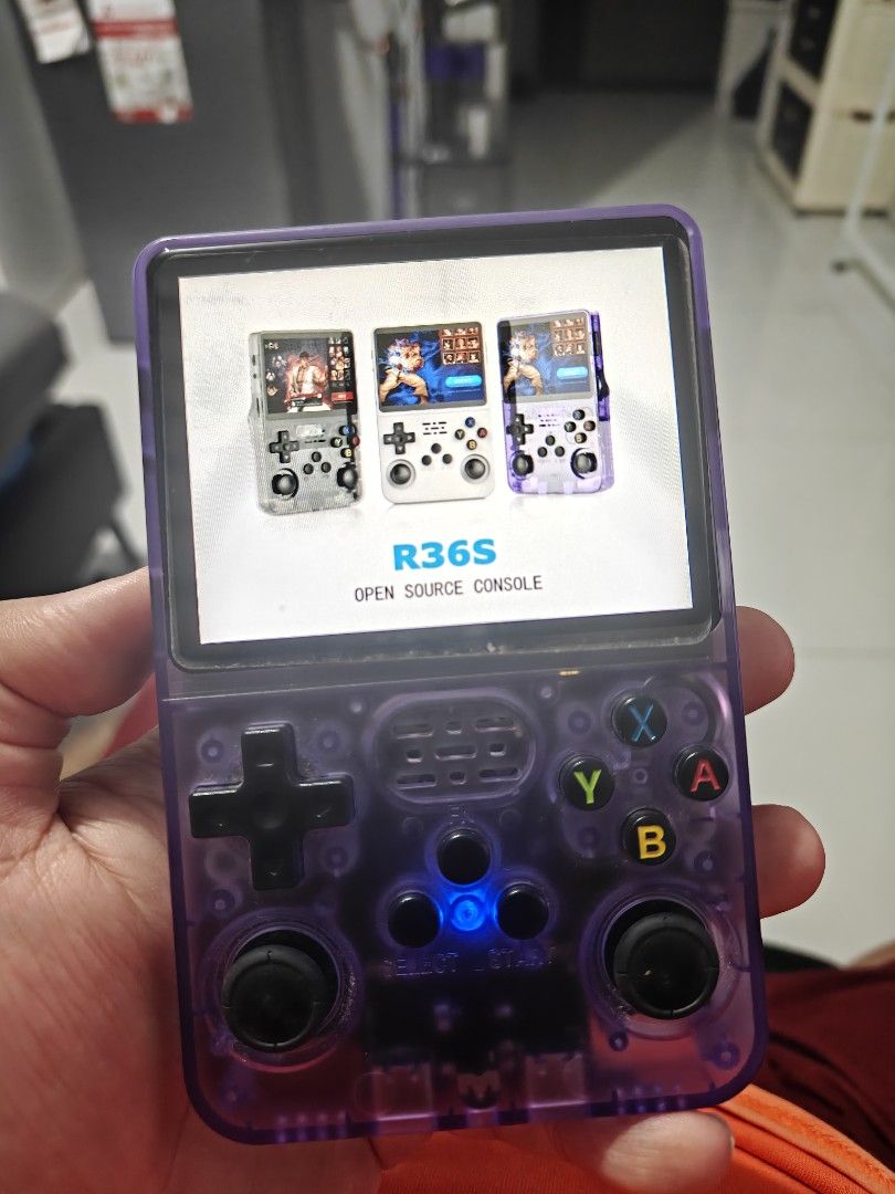 R36S Open Source Purple Handheld Game Console (Category: Nintendo) located in Tarlac. Submitted by raphocehcap (Listing ID 1469867472, Image 2). Description: Good as new slightl used. 25,000 Games (128gb card/ 2nd slot) Display: 3.5- inch IPS full viewing angle,640*480 Processor: ARM64 bit quad core A35 Cortex 1.5Ghz Default Memory storage:64GB/128G TF/MicroSD TF card: Dual card slot, support TF card expansion Colors: Transparent Purple/Transpare