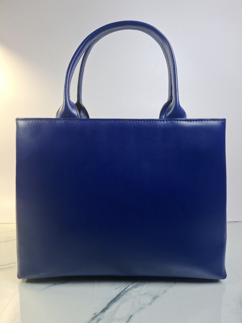 Ra Iride Blue Leather Tote Handbag (Category: Tote Bags) located in Pasay City. Submitted by onick_79 (Listing ID 1469928279, Image 1). Description: - Dimensions: L 30 x H 24 x W 7.5 cm - Brand: Ra Iride - Color: Vibrant blue - Material: Premium leather - Features: Double top handles and exterior zip pocket with branded hardware pull - Protection: Metal feet on the bottom for extra durability - Design: Clean lines, classic shape, and solid struct