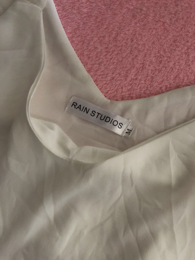 Rain Studios White V-Neck Tank Top Size M (Category: Sleeveless) located in Manila. Submitted by seethestarrz (Listing ID 1469855837, Image 2). Description: 📍qc, metro manila 🚚 jnt, sf shouldered by buyer.