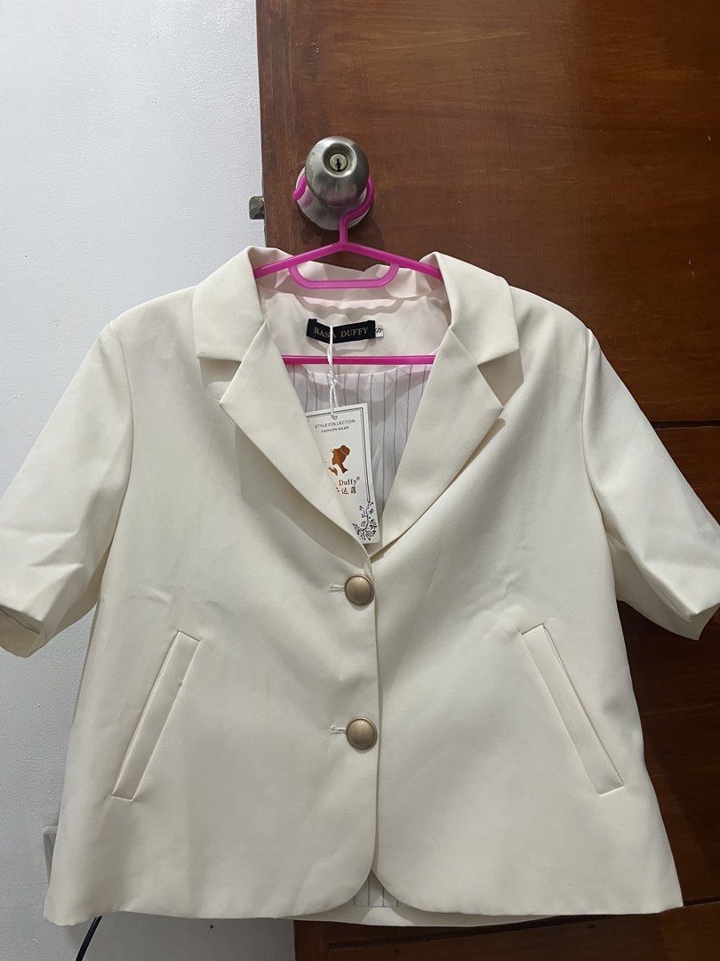Rasa Duffy White Short Sleeve Blazer Size S (Category: Blouses) located in Manila. Submitted by thepinkshop_ (Listing ID 1469882376, Image 1). Description: - Color: Crisp White - Size: Small - Condition: Brand new with brand tag and hanging label attached - Design: Short sleeve blazer with two gold-toned front buttons - Pockets: Functional front pockets - Lining: Stylish striped inner lining - Ideal for: Office wear, smart casual, or events.