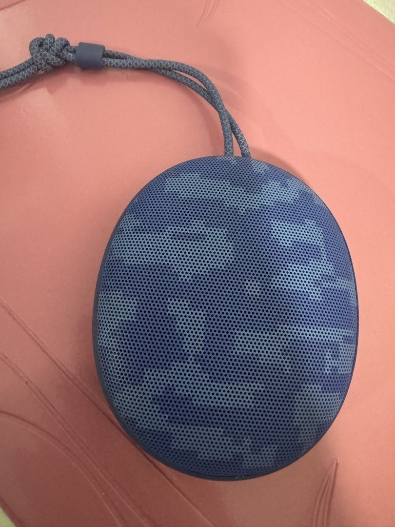 realme Bluetooth Speaker (Category: Soundbars, Speakers & Amplifiers) located in Manila. Submitted by decluterthings888 (Listing ID 1469925827, Image 2). Description: - Brand: Realme - Connectivity: Wireless Bluetooth - Design: Stylish blue camouflage pattern with a compact circular build - Portability: Includes a sturdy woven hanging strap and non-slip rubber footing - Usage: Perfect for both indoor and outdoor listening.