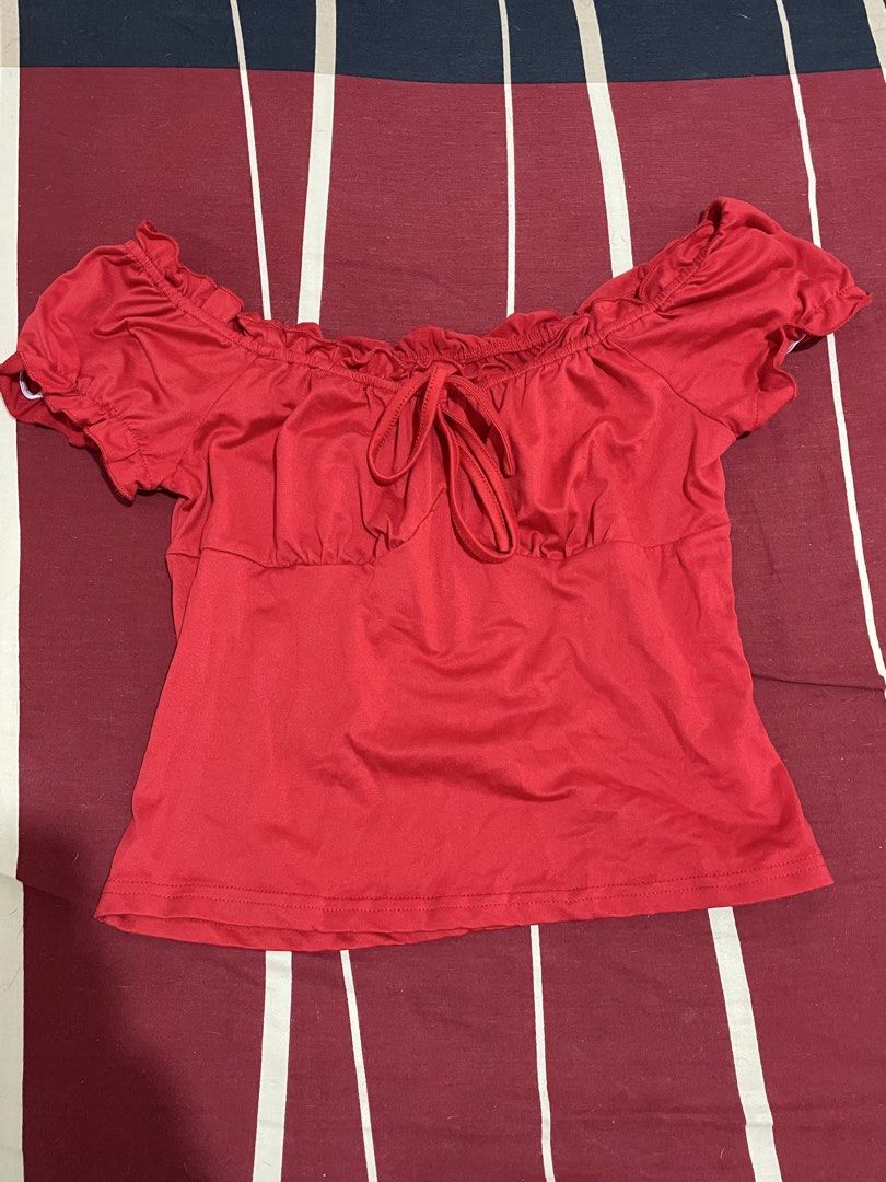 Red Off Shoulder Crop Top with Bow Detail (Category: Blouses) located in Manila. Submitted by alysaysyys_ (Listing ID 1469829422, Image 1). Description: - Bright red off-shoulder design - Short ruffled sleeves - Cinched elastic bust line for a comfortable fit - Adjustable front tie ribbon in the center - Lightweight stretch material - Simple hem at the bottom.