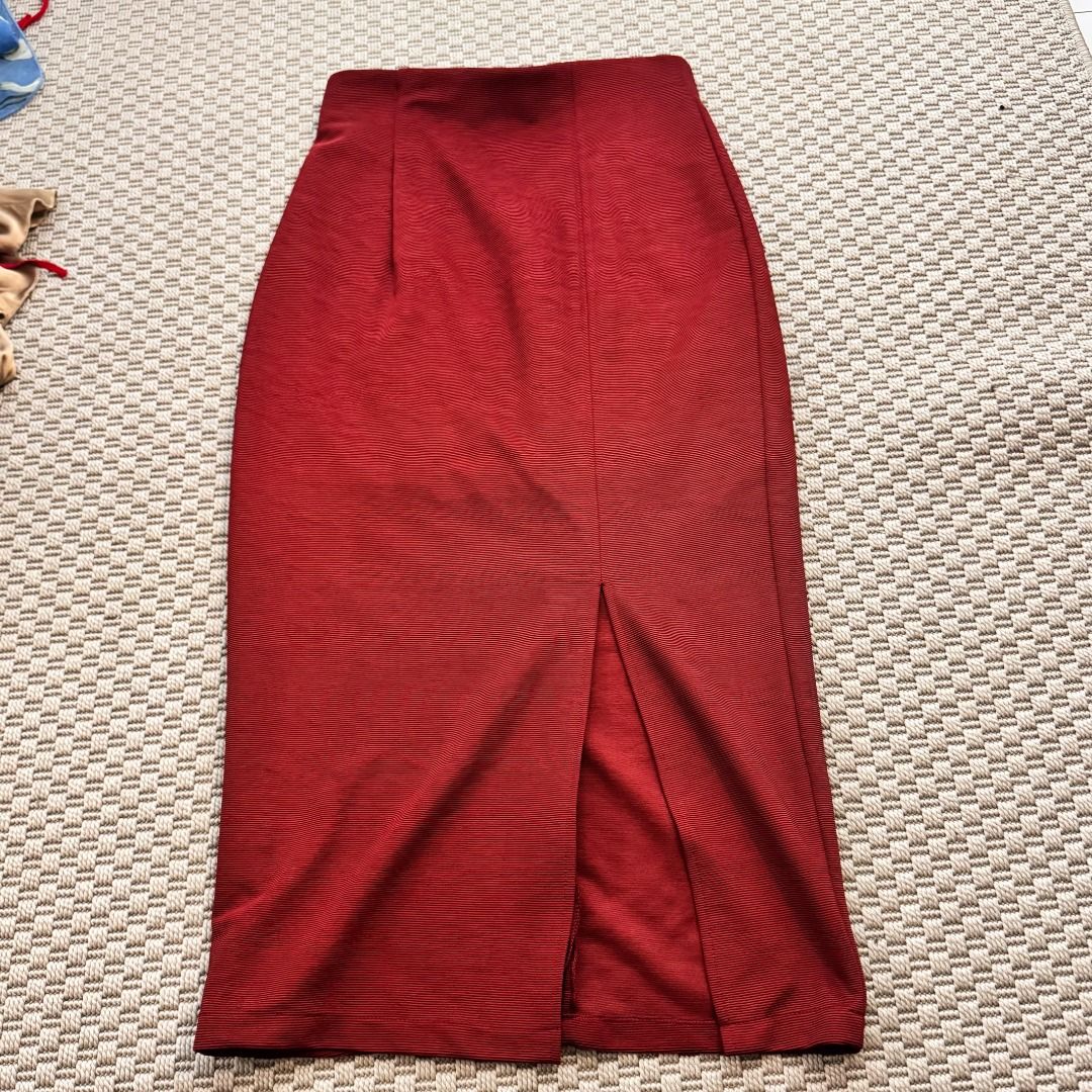 Red Pencil Skirt with Front Slit (Category: Skirts) located in Marikina City. Submitted by repurpose_studio (Listing ID 1469783382, Image 2). Description: - Style: Fitted bodycon midi skirt with front slit at the hem - Color: Rich red - Material: Structured textured fabric with stretch - Closure: Back zipper with clean-finish waistband - Occasion: Perfect for work, meetings, or going out.
