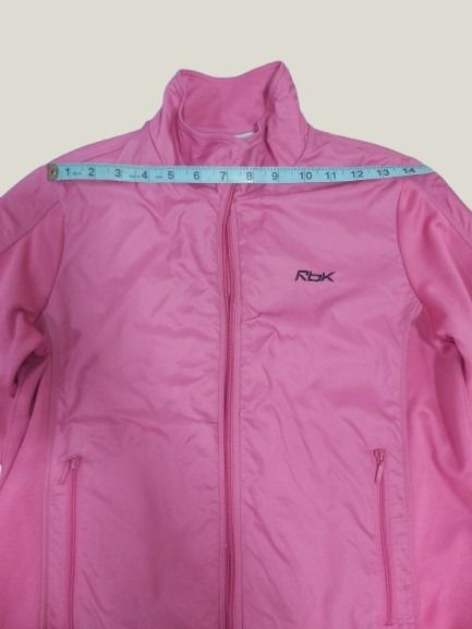 REEBOK Pink Zip-Up Track Jacket (Category: Coats, Jackets and Outerwear) located in Davao. Submitted by rosewyn (Listing ID 1469903988, Image 3). Description: - Color: Bright pink - Style: Zip-up jacket with high collar and side panel details - Fit: Ribbed cuffs and bottom hem to keep it snug - Material: Soft and comfortable - Versatility: Ideal for workouts or casual daily wear - Closure: Full front zipper with a small pull tab - Zipper (hard to