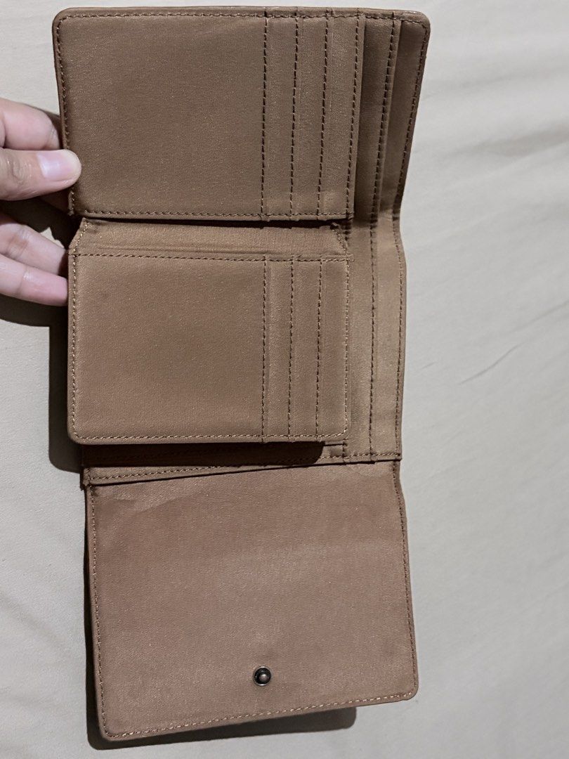 Relic Brown Leather Trifold Wallet (Category: Wallets & Card holders) located in Quezon City. Submitted by angelajuliet__ (Listing ID 1469921065, Image 3). Description: - Brand: Relic - Material: Brown pebbled leather with white contrast stitching - Closure: Secure snap button - Exterior: Handy zip pocket for coins or small items - Interior: Multiple card slots, ID window, and cash compartments - Condition: Clean inside and out, well-maintained -