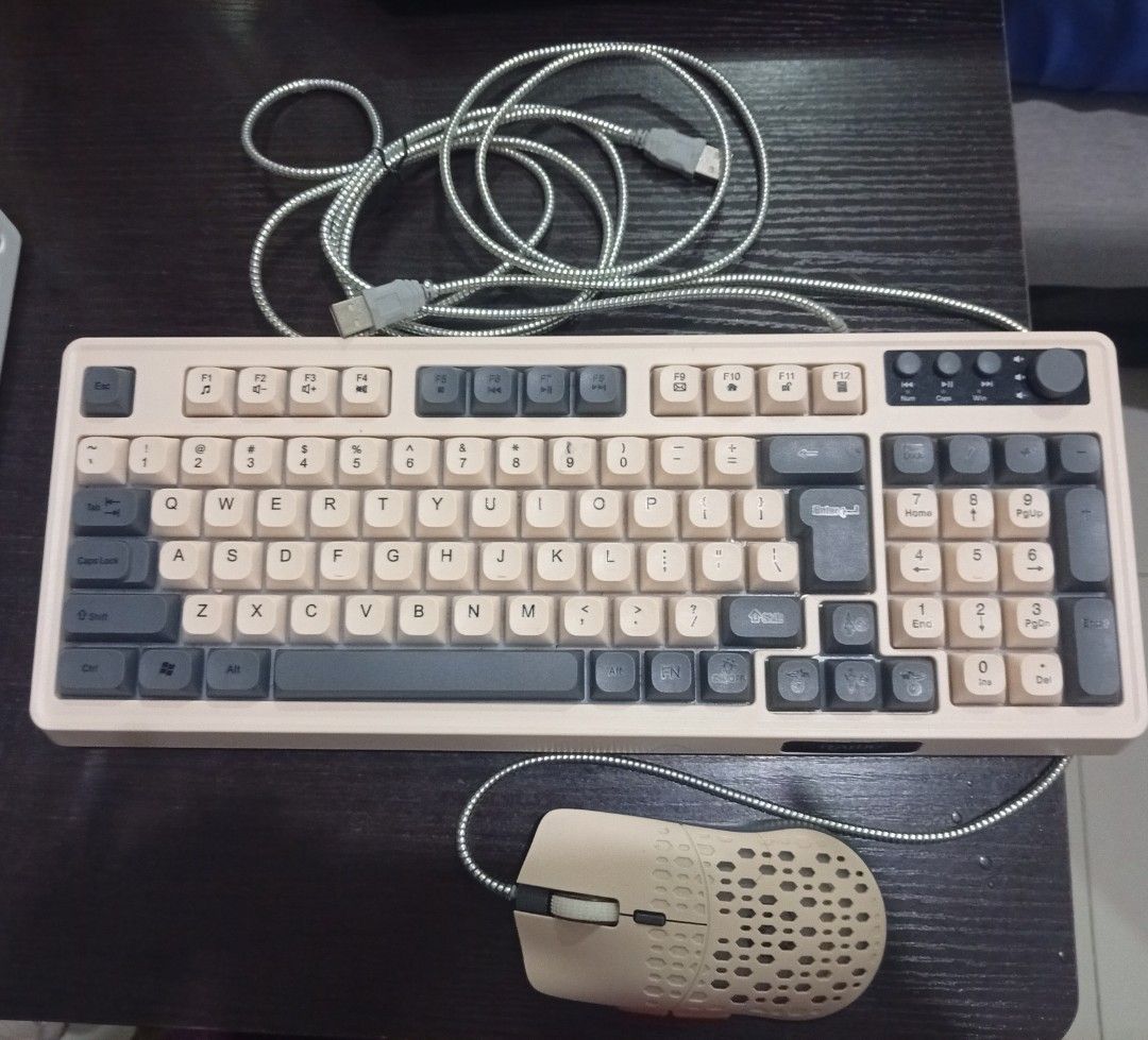 Retro beige mechanical keyboard and honeycomb mouse set (Category: Computer Keyboard) located in Makati City. Submitted by warm.berniekahn (Listing ID 1469899531, Image 1). Description: - Retro mechanical keyboard and matching honeycomb gaming mouse bundle - Durable silver braided cables for both wired devices - Keyboard features a full numeric keypad and top-right multimedia knobs - Customizable RGB backlighting across all keys and mouse body - 