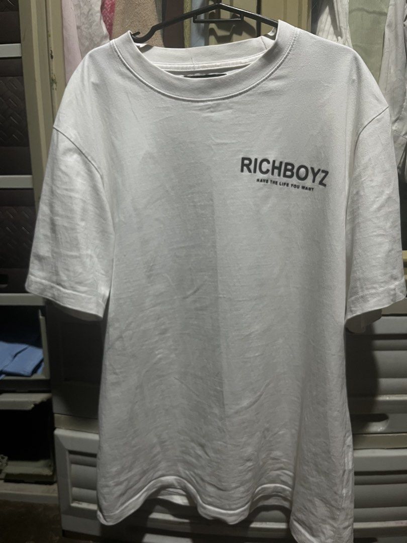 Richboyz White Graphic T-Shirt (Category: Tshirts & Polo Shirts ) located in Taguig. Submitted by kiyo_55 (Listing ID 1469934206, Image 2). Description: - Brand: Richboyz - Color: Classic White - Material: 100% Cotton - Fit: Regular fit, short sleeves, crew neckline - Design: 'Richboyz' chest print with 'have the life you want' text; large back graphic - Condition: Excellent, clean fabric with no stains, holes, or fading - Mode of Payment: GCash,