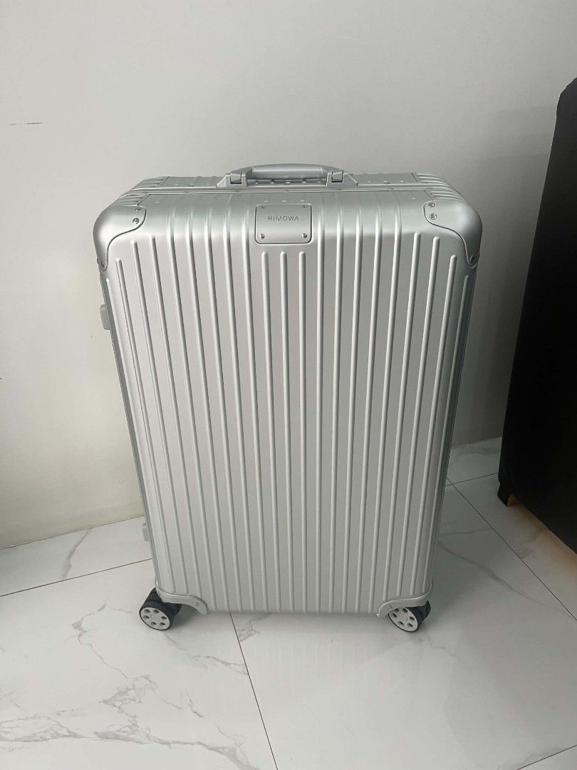 Rimowa Aluminium Suitcase Silver Check in (Category: Luggage) located in Paoay. Submitted by rvf1230 (Listing ID 1469810634, Image 2). Description: - Brand: Rimowa - Material: Premium silver aluminium with iconic grooved design - Condition: Excellent, clean exterior with no major scratches or dents - Mobility: Smooth multi-wheel system and adjustable telescopic handle - Hardware: Sturdy metal hinges, corner guards, and clearly engraved logo badge