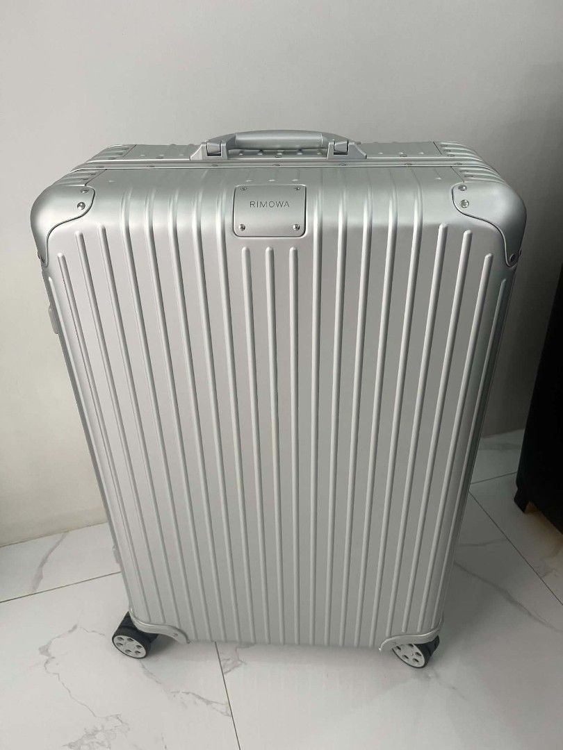 Rimowa Aluminium Suitcase Silver Check in (Category: Luggage) located in Paoay. Submitted by rvf1230 (Listing ID 1469810634, Image 1). Description: - Brand: Rimowa - Material: Premium silver aluminium with iconic grooved design - Condition: Excellent, clean exterior with no major scratches or dents - Mobility: Smooth multi-wheel system and adjustable telescopic handle - Hardware: Sturdy metal hinges, corner guards, and clearly engraved logo badge