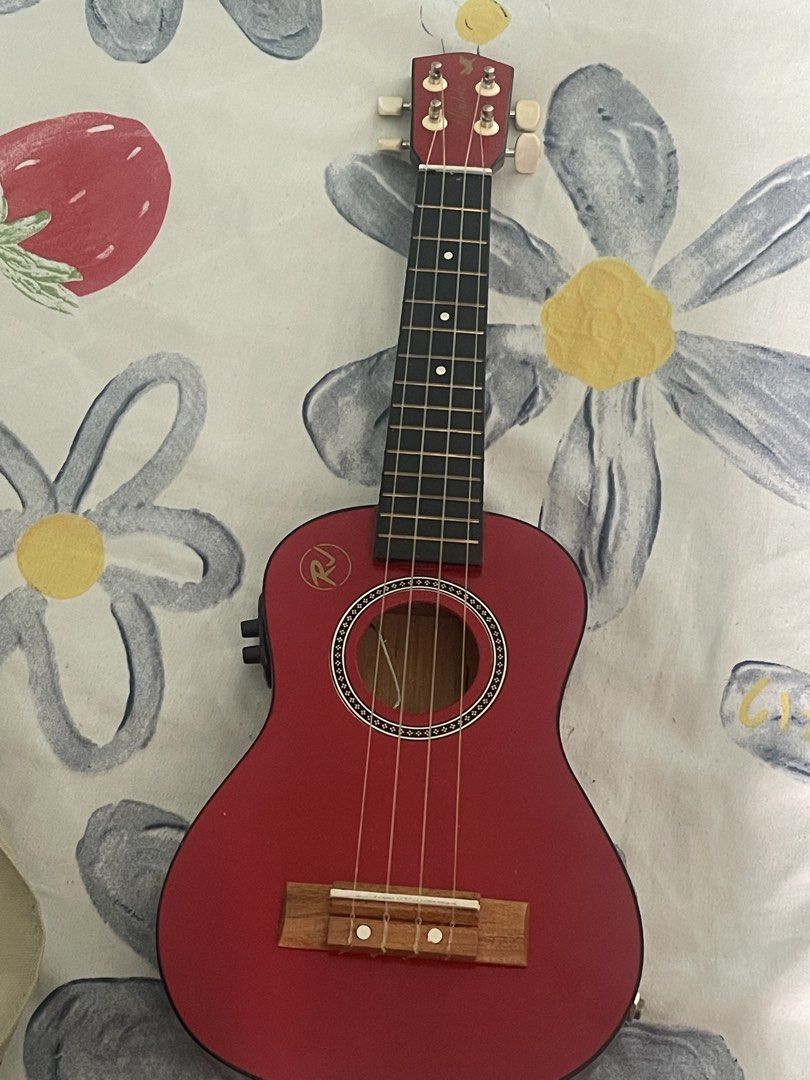RJ Red Acoustic Ukulele with Gig Bag (Category: Musical Instruments) located in Pasig City. Submitted by declutternsale28 (Listing ID 1469801320, Image 1). Description: Not used. Gift given rfs: not use at home - Brand/Model: RJ acoustic-electric ukulele - Color: Striking red finish with elegant dark wood back and sides - Electronics: Built-in controls on the side for easy amplification - Condition: Clean body and neck, ready to play - Inclusion: