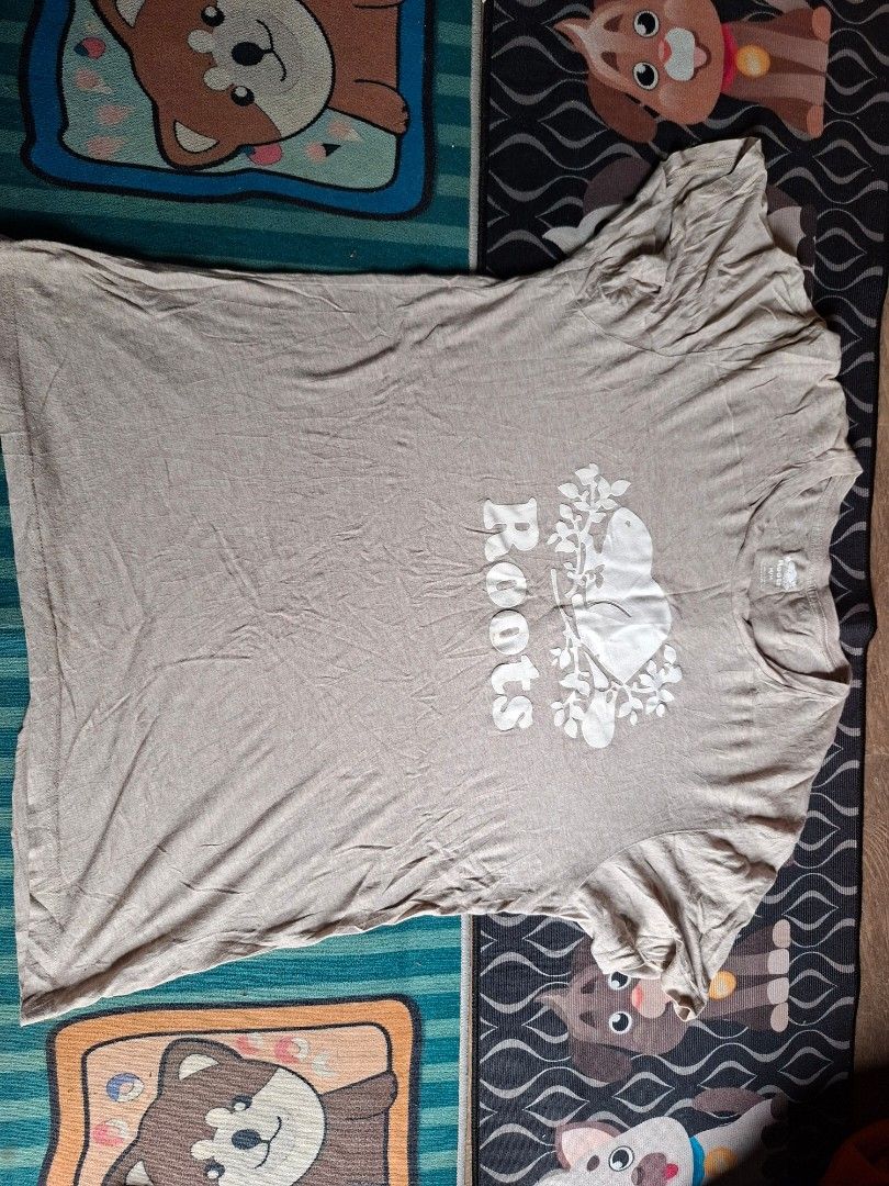 Roots Beaver Logo Brown T-Shirt Size M (Category: Tshirts & Polo Shirts ) located in San Francisco. Submitted by manu2025 (Listing ID 1469937381, Image 1). Description: - Brand: Roots - Color: Brown with classic beaver logo and text graphic - Size: Medium (tag at collar) - Material: 100% organic cotton - Fit/Style: Short sleeves, crew neck, casual everyday wear - Condition/Fit: Measurements provided in photos.