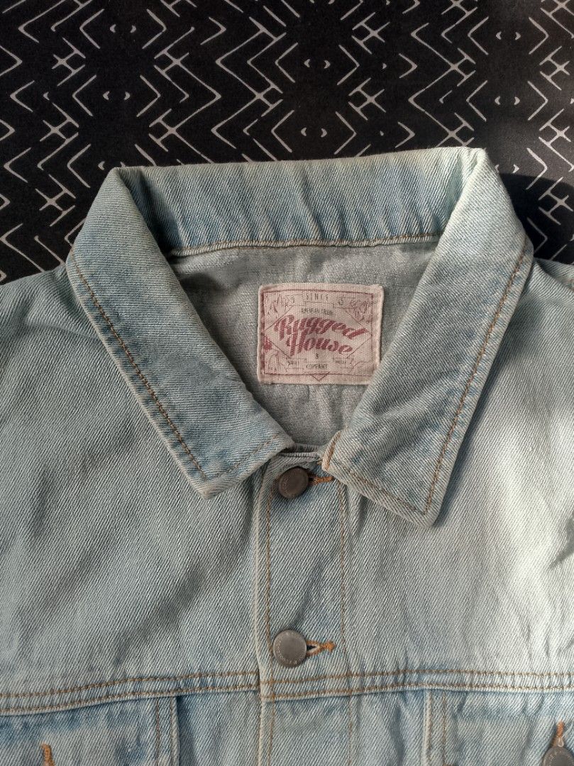 Rugged House Light Wash Denim Jacket 3XL (Category: Coats, Jackets and Outerwear) located in Bacolod City. Submitted by surfwear_in_negros (Listing ID 1469946077, Image 1). Description: - Brand: Rugged House - Style: Classic denim trucker jacket - Color: Light blue wash - Size: 3XL - Features: Button-up front, branded metal hardware, dual chest flap pockets, structured collar, contrast stitching - Material: Durable denim - Care: Machine wash cold