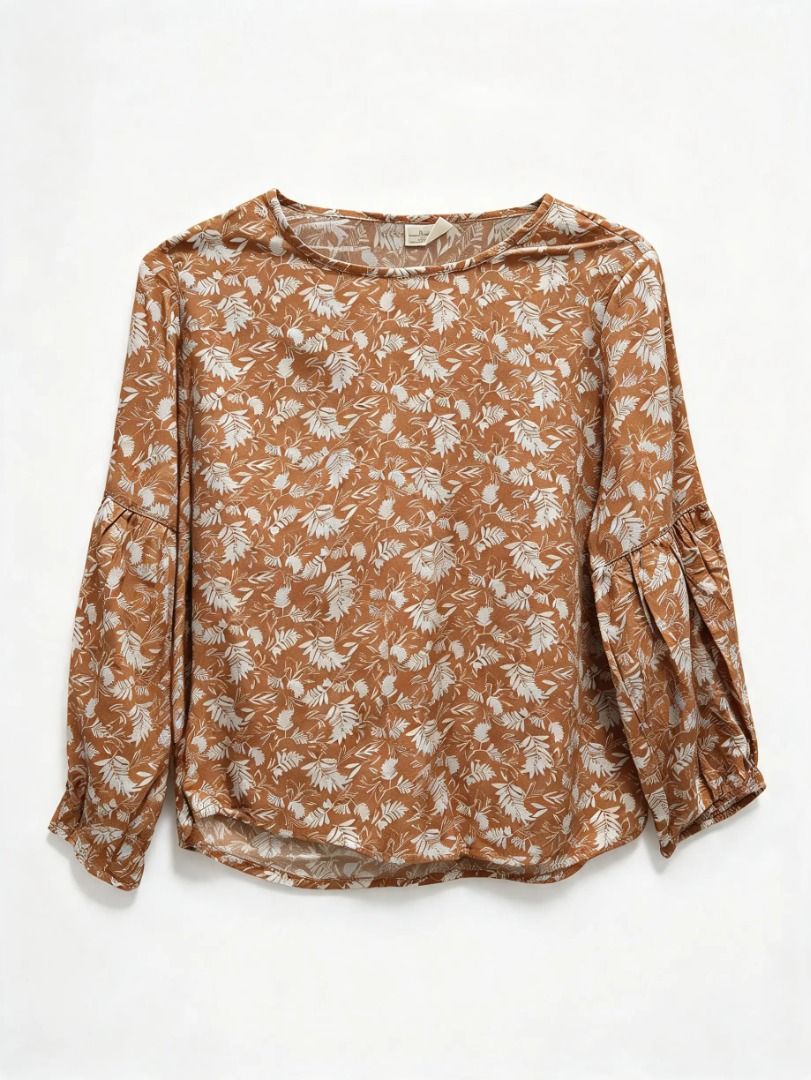 Rust Brown Floral Print Long Sleeve Blouse (Category: Longsleeves) located in San Jose del Monte. Submitted by shopkcscloset (Listing ID 1469824495, Image 1). Description: - Color/Pattern: Rust brown with all-over white floral and leaf print - Fit: Relaxed and lightweight for all-day comfort - Neckline: Classic round neckline - Sleeves: Long sleeves with stylish gathered puff cuffs - Style: Easy pullover design, perfect for pairing with jeans or 