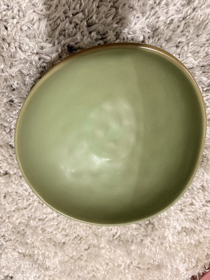 Sage Green Ceramic Serving Bowl Organic Shape (Category: Dinnerware & Cutlery) located in Mandaluyong City. Submitted by riz_040521 (Listing ID 1469797520, Image 1). Description: - Color: Sage green - Material: Solid stoneware - Finish: Smooth matte interior, slightly textured exterior - Design: Organic wavy shape with a raised foot base - Versatility: Ideal for soups, salads, and snacks - Aesthetic: Perfect for minimalist table settings.