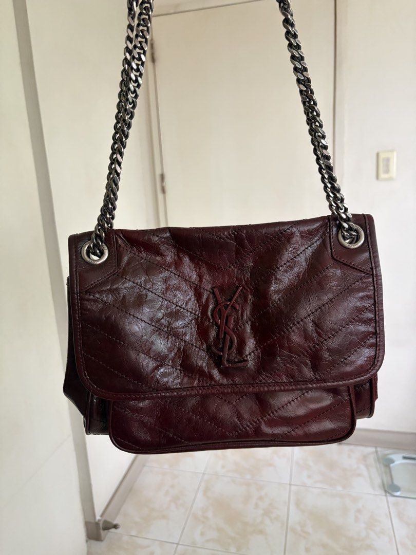 Saint Laurent Niki Medium Chain Bag Burgundy (Category: Luxury Bags & Wallets) located in Caloocan City. Submitted by theprelovedpurse (Listing ID 1469880985, Image 2). Description: - Brand: Saint Laurent (YSL) Niki Shoulder Bag - Color/Material: Deep burgundy crinkled leather with dark metallic hardware - Design: Quilted chevron stitching with signature matching YSL front monogram - Compartments: Spacious interior layout with a convenient front 