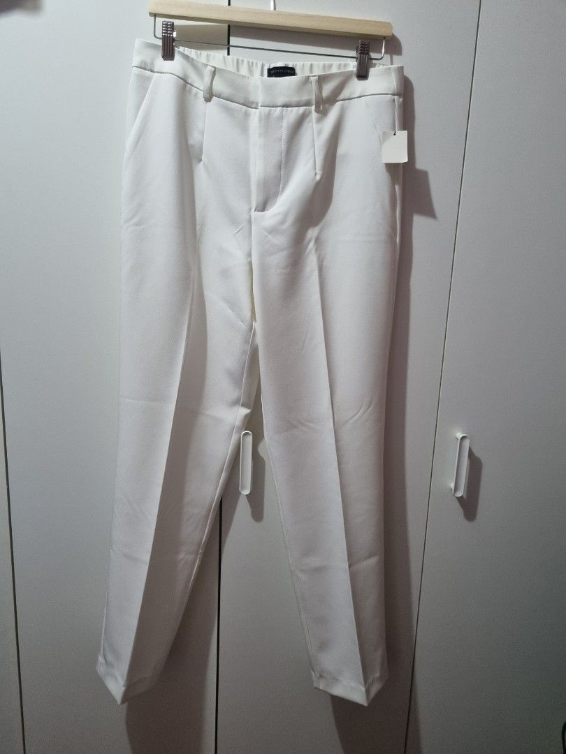 Saks Fifth Avenue White Trousers (Category: Other Bottoms) located in Taguig. Submitted by jacky700574 (Listing ID 1469941966, Image 1). Description: - Brand: Saks Fifth Avenue - Condition: Brand new with original tags attached - Color: Crisp solid white - Fit: Tailored fit with center creases and high rise waist - Features: Belt loops and functional side pockets - Style: Clean minimalist look, ideal for office wear or smart casual outfits.