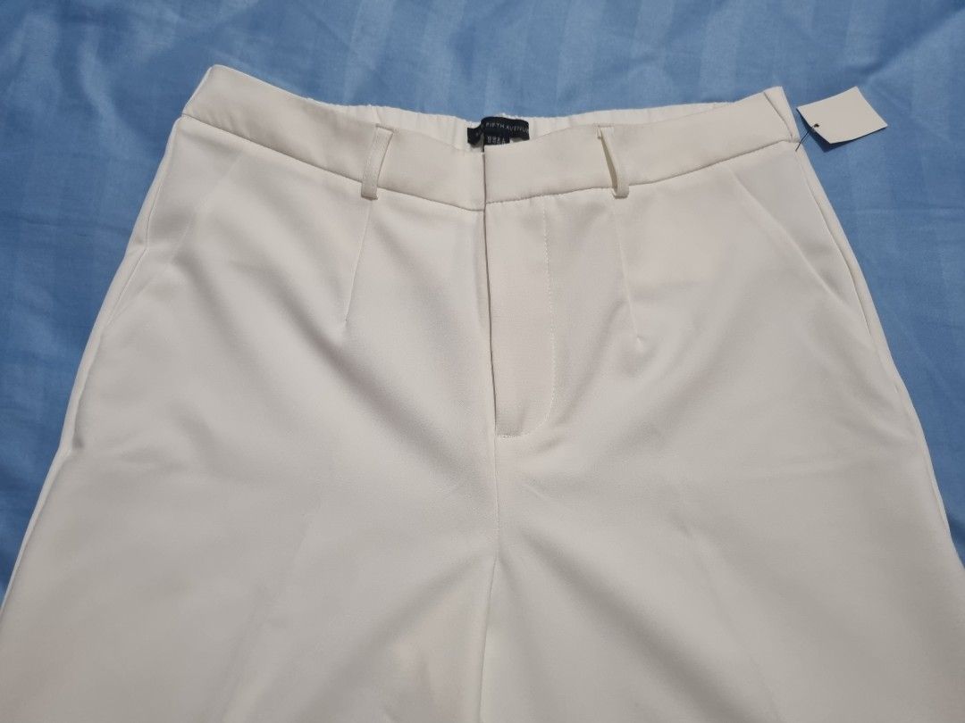 Saks Fifth Avenue White Trousers (Category: Other Bottoms) located in Taguig. Submitted by jacky700574 (Listing ID 1469941966, Image 2). Description: - Brand: Saks Fifth Avenue - Condition: Brand new with original tags attached - Color: Crisp solid white - Fit: Tailored fit with center creases and high rise waist - Features: Belt loops and functional side pockets - Style: Clean minimalist look, ideal for office wear or smart casual outfits.