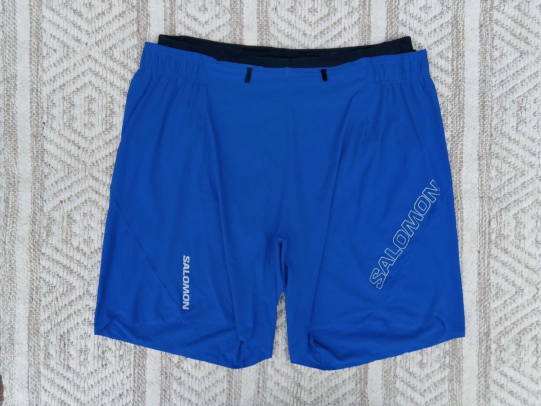 Salomon Running Shorts Blue Size L (Category: Shorts) located in Quezon City. Submitted by cruz_robert (Listing ID 1469808373, Image 2). Description: - Brand: Salomon - Color: Bright blue with bold white logos - Size: L (Tag on inner waistband) - Features: Attached black inner liner, elastic waistband with interior drawstring loops - Origin: Made in Bangladesh - Condition: Clean fabric inside and out.