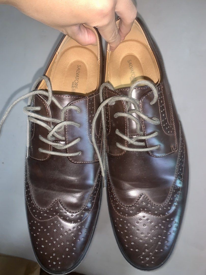 Salvatore Mann Bennet BS Brown Size 13 (Category: Dress Shoes) located in Caloocan City. Submitted by ekivilleg86508 (Listing ID 1469851345, Image 3). Description: - Brand/Model: Salvatore Mann Bennet - Size: 13 US Men's - Color: Dark brown with textured grey laces - Style: Classic lace-up wingtip brogues with decorative perforations - Comfort: Equipped with Salvatore Mann Comfort cushioned insoles - Soles: Thick black rubber block heels and sole