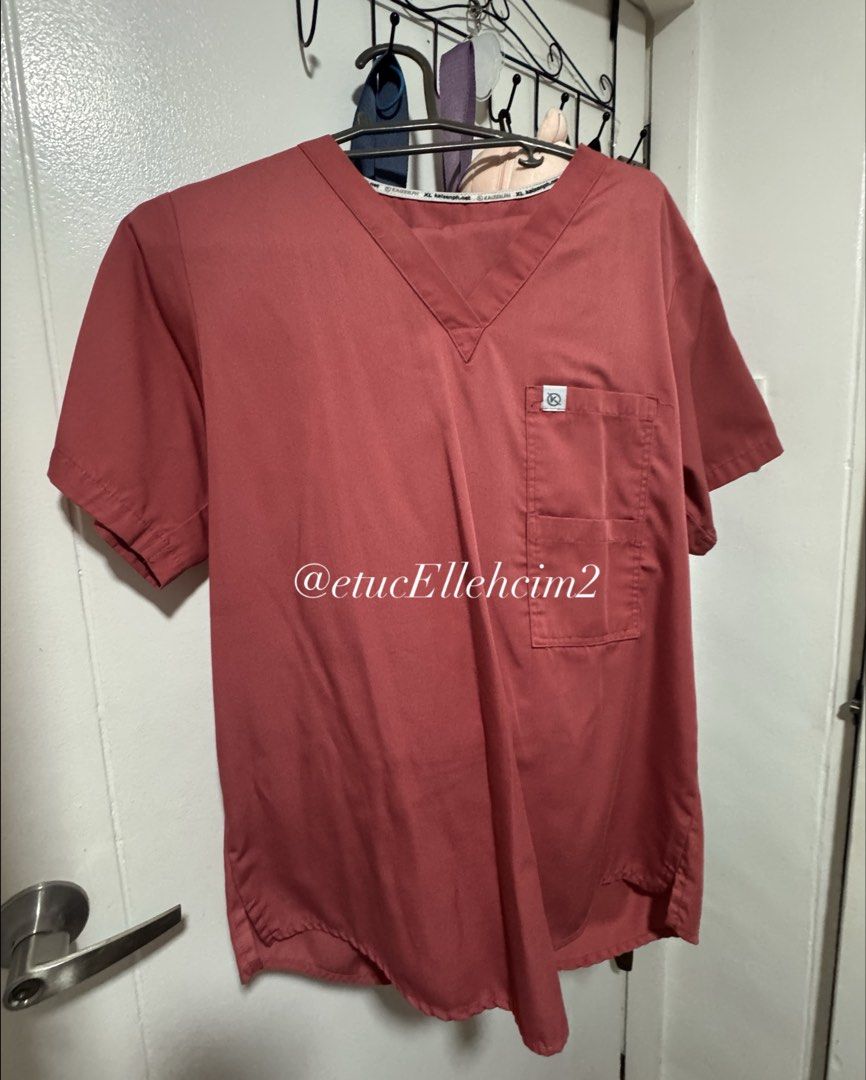 Scrubs Set Top and Pants (Category: Sets or Coordinates) located in Pasay City. Submitted by michmonteros (Listing ID 1469870941, Image 1). Description: Rust Color medical scrub set, matching top and pants. V-neck top with front chest pocket. Pants feature an elastic waistband with a white drawstring. Flat lay measurements included in pictures. Shoulder 17.5 inches, width 51.5 cm, length 71 cm for top. Pants waist stretches to 48 cm, relaxed 32 c