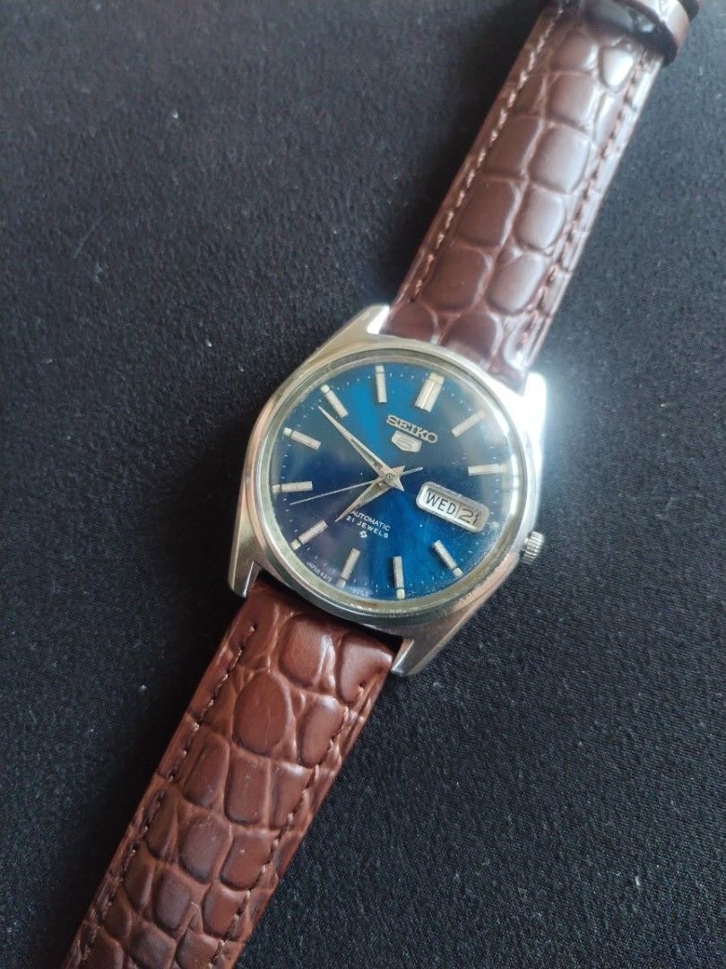 Seiko 5 Automatic 21 Jewels Blue Dial Watch (Category: Men's Watches) located in Pasig City. Submitted by BeatsandTicks (Listing ID 1469828257, Image 1). Description: - Model: Seiko 5 Automatic Watch - Dial: Striking blue with silver hands and hour markers - Features: Convenient day-date window at 3 o'clock - Movement: Reliable 21 jewels automatic movement - Strap: Classic silver-tone case paired with a brown embossed leather strap - Condition: G