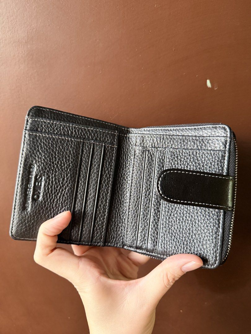 Seiko Black Genuine Leather RFID Wallet (Category: Wallets & Card Holders) located in Batangas. Submitted by intyl_preloved.bags (Listing ID 1469944933, Image 2). Description: - Genuine black leather with stylish white stitching details - Built-in RFID blocking technology to keep your cards secure - Multiple card slots, spacious cash compartment, and zipped coin pocket - Handcrafted finish for a premium look and feel - Comes complete with origina