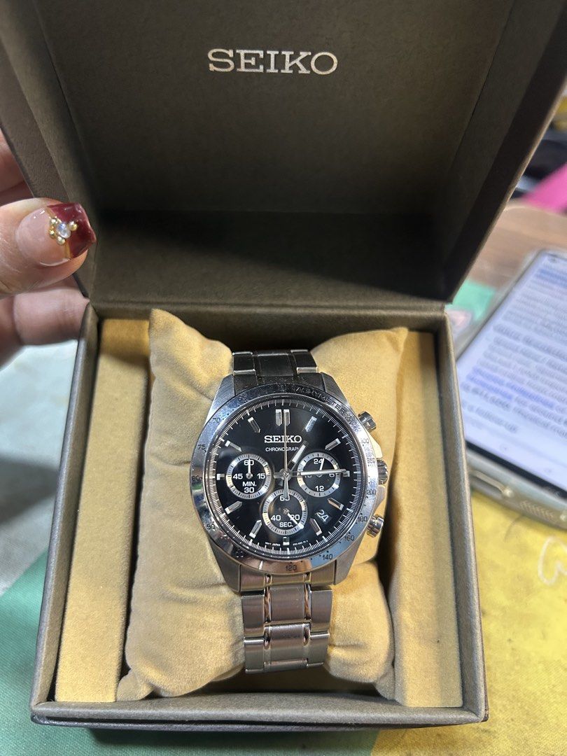 Seiko Chronograph Tachymeter Quartz Watch with Box (Category: Men's Watches) located in Cavite. Submitted by mamamia73 (Listing ID 1469931680, Image 1). Description: - Brand: Seiko - Movement: Quartz Chronograph - Dial: Black with 3 sub-dials and tachymeter bezel - Material: Stainless steel case and bracelet - Condition Note: Bracelet clasp features Casio replacement branding - Details: Case back stamped 8T63-00P0, Serial #894497 - Inclusion: Ori