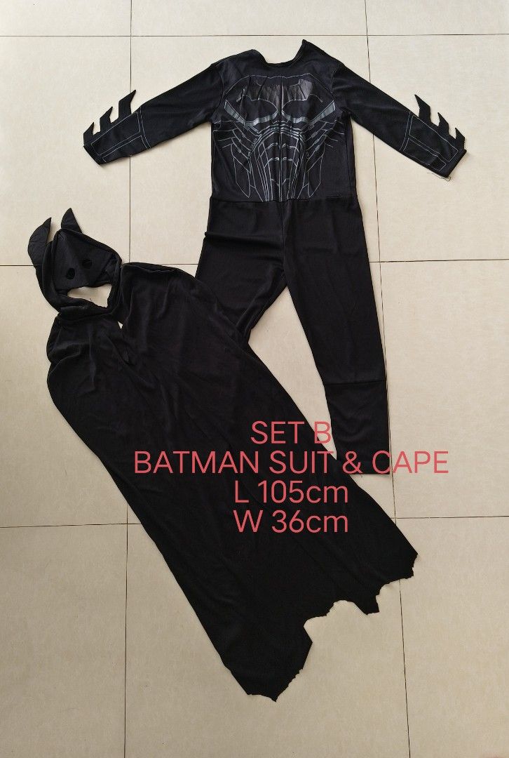 SET B Batman Suit & Cape L 105cm W 36cm (Category: Babies & Kids Fashion) located in Paranaque City. Submitted by pickleandpumpkeen (Listing ID 1469914175, Image 1). Description: - SET B Batman costume set for kids/event - Includes long sleeve printed jumpsuit, detachable cape, and matching headpiece with bat ears - Design: Black material with cool silver chest armor graphics and arm spikes - Size: Length 105cm, Width 36cm pls refrain from asking