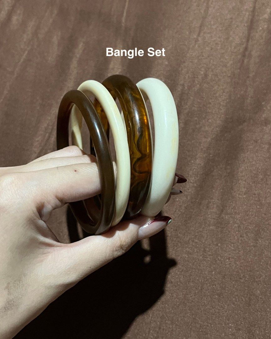 Set of 4 chunky bangles in earth tones (Category: Bracelets) located in Manila. Submitted by maaya.rikit (Listing ID 1469936192, Image 1). Description: - Set of 4 chunky bangles - Colors: 2 white/off-white, 1 dark brown, 1 tortoiseshell amber - Glossy finish - Perfect for daily wear and stacking - Easy to mix and match with any outfit.
