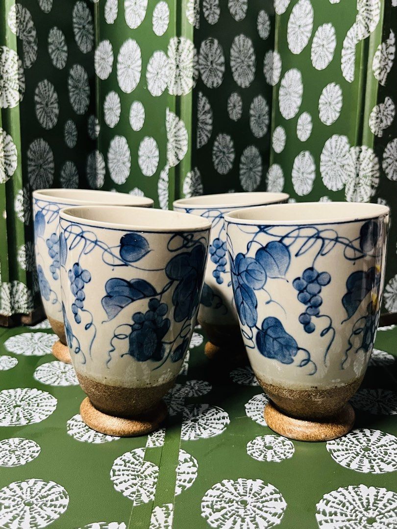Set of 4 Japanese style ceramic cups with grape vine pattern (Category: Coffee & Tea Tableware) located in Malabon City. Submitted by mgsurplus (Listing ID 1469772404, Image 1). Description: - Set of 4 ceramic cups - Beautiful blue and white hand-painted grape vine design - Cream glazed body with textured brown base and raised foot - Great for hot or cold drinks like coffee and tea - Solid build with a comfortable grip.