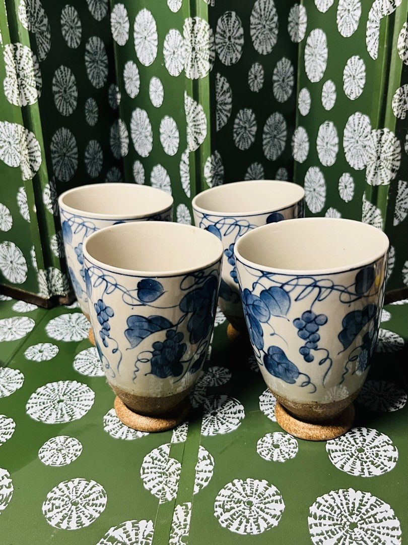 Set of 4 Japanese style ceramic cups with grape vine pattern (Category: Coffee & Tea Tableware) located in Malabon City. Submitted by mgsurplus (Listing ID 1469772404, Image 2). Description: - Set of 4 ceramic cups - Beautiful blue and white hand-painted grape vine design - Cream glazed body with textured brown base and raised foot - Great for hot or cold drinks like coffee and tea - Solid build with a comfortable grip.