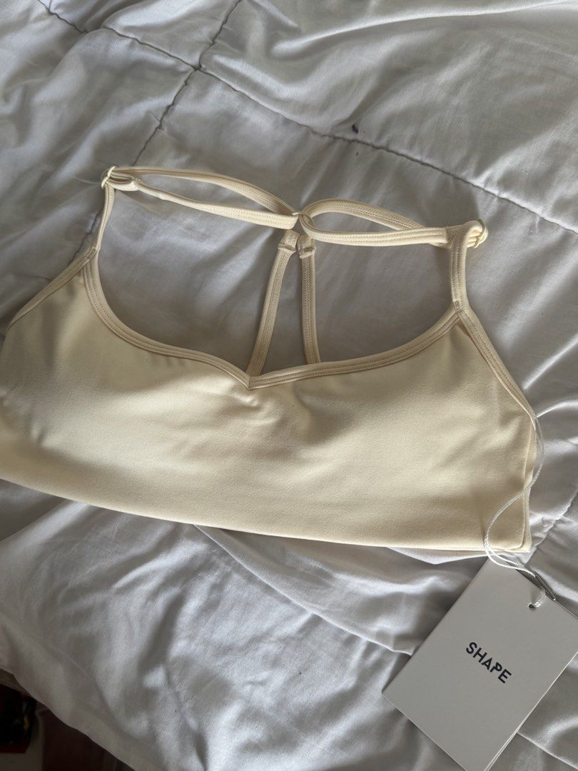 BNWT SHAPE Active Tone Sports Bra Cream Size S (Category: Activewear) located in Pasig City. Submitted by vanillaice__ (Listing ID 1469929091, Image 1). Description: - Brand New with tags - Color: Cream yellow - Condition: Brand new with tags (never worn) - Design: Scoop neckline with a stylish multi-strap back - Material: Soft and comfortable stretch fabric.